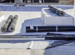 crew installing white tpo membrane over aging bur on a seattle warehouse
